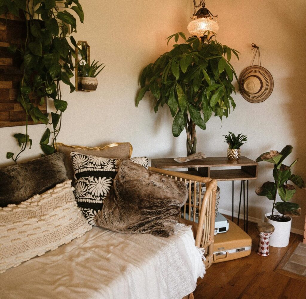A warm, stylish boho living room featuring houseplants and wooden decor.